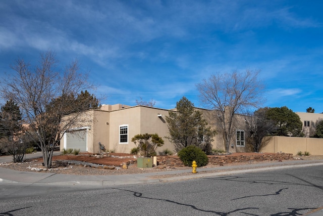 adobe home featuring a garage