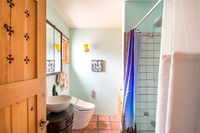 full bathroom featuring toilet, tile patterned floors, vanity, and shower / bath combo with shower curtain