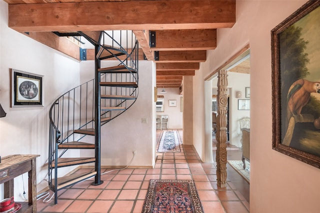 stairs featuring tile patterned floors and beam ceiling