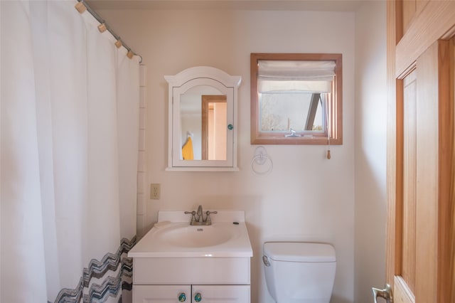 bathroom featuring toilet and vanity