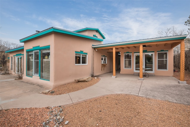 rear view of house with a patio area and ceiling fan