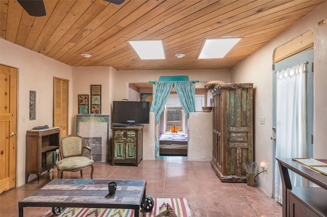 living room with plenty of natural light, a skylight, and wood ceiling