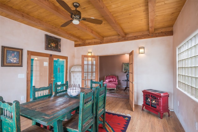 dining space featuring ceiling fan, beamed ceiling, light wood-type flooring, wood ceiling, and french doors