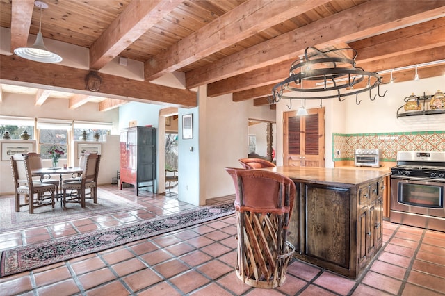 kitchen featuring a center island, track lighting, stainless steel range oven, wood ceiling, and decorative backsplash