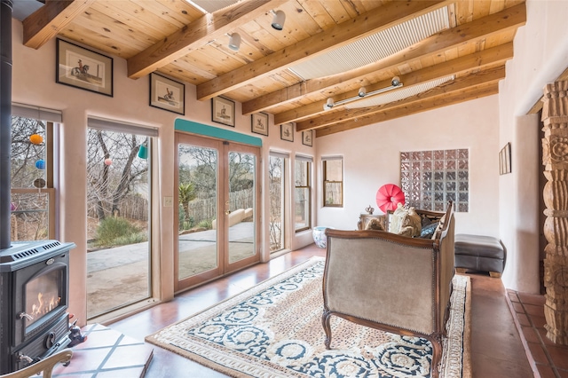 home office featuring wood ceiling, wood-type flooring, french doors, beamed ceiling, and a wood stove