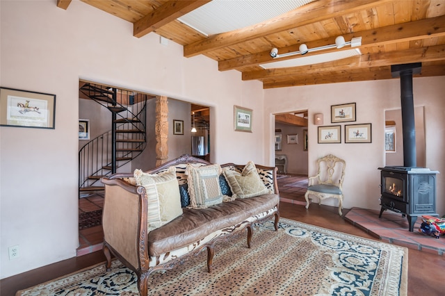 living room featuring wood ceiling, a wood stove, and beamed ceiling