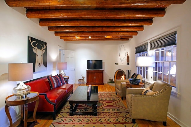 living room with beamed ceiling, wooden ceiling, and hardwood / wood-style floors