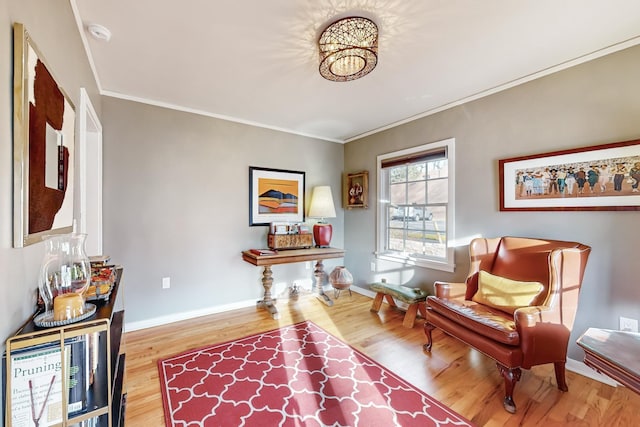 sitting room featuring light hardwood / wood-style flooring and crown molding