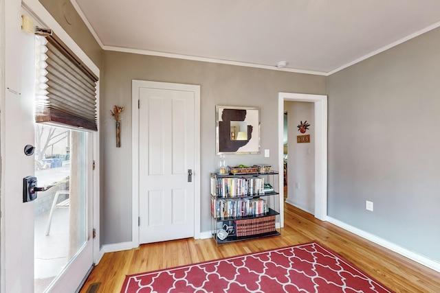 entrance foyer with hardwood / wood-style flooring and ornamental molding