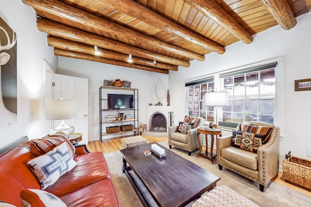 living room featuring beam ceiling, light wood-type flooring, and wood ceiling