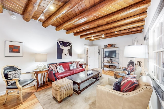 living room featuring beam ceiling, wooden ceiling, and light wood-type flooring