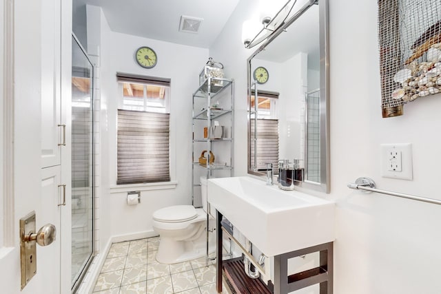 bathroom featuring tile patterned flooring, an enclosed shower, and toilet