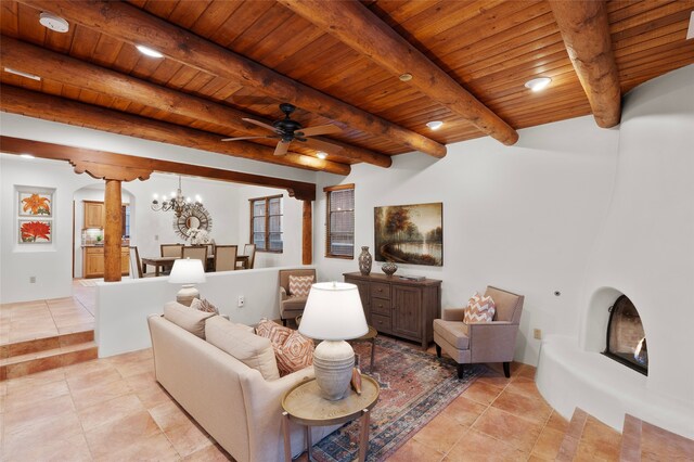 tiled living room with beam ceiling, ceiling fan, and wooden ceiling