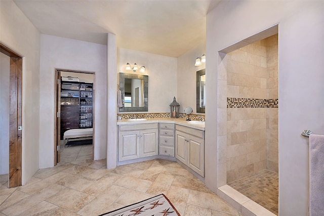 bathroom with a tile shower, decorative backsplash, and vanity