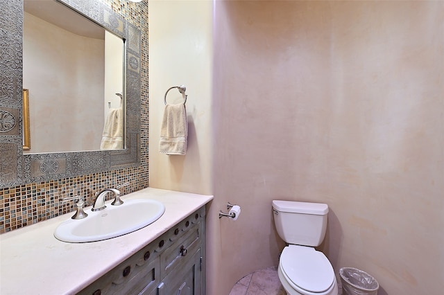 bathroom featuring backsplash, vanity, and toilet