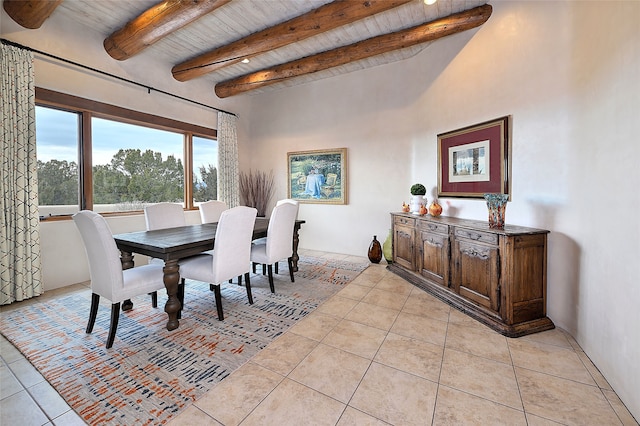 dining space with beam ceiling, wooden ceiling, and light tile patterned floors