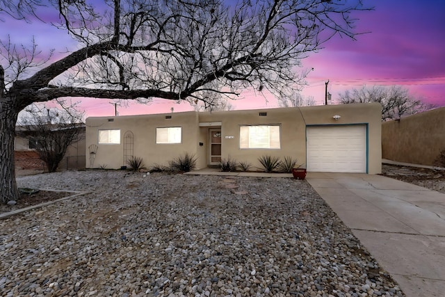 adobe home featuring a garage