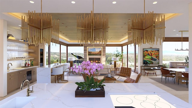 dining room featuring a tray ceiling, a wealth of natural light, and sink