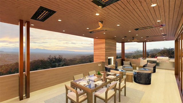 exterior space featuring outdoor lounge area, ceiling fan, grilling area, a mountain view, and area for grilling