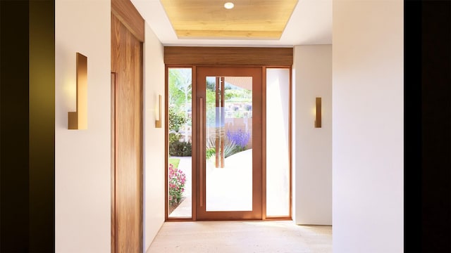 doorway featuring a tray ceiling