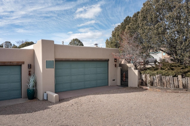 pueblo-style home with a garage