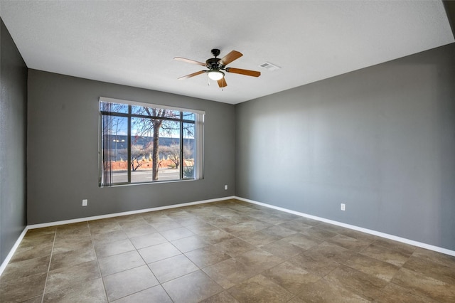 empty room featuring ceiling fan and a textured ceiling