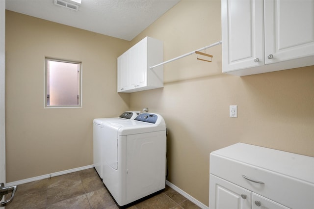 washroom with cabinets and independent washer and dryer