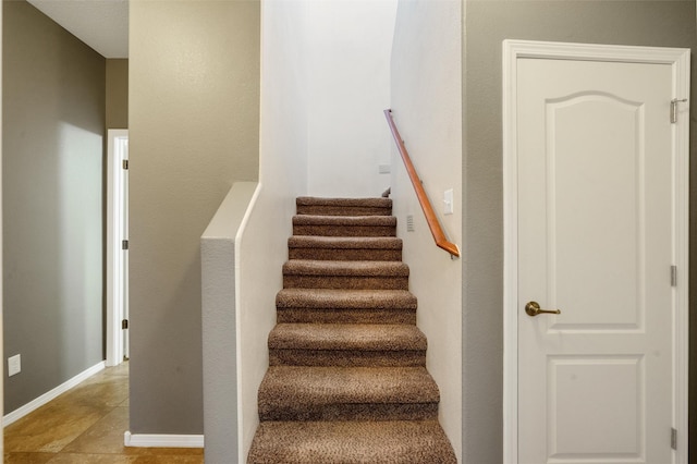 stairs featuring tile patterned floors