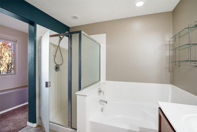 bathroom featuring vanity and independent shower and bath