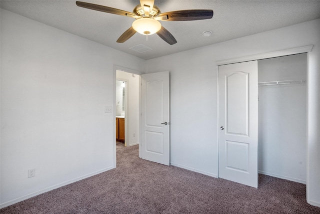 unfurnished bedroom featuring carpet floors, a closet, and ceiling fan