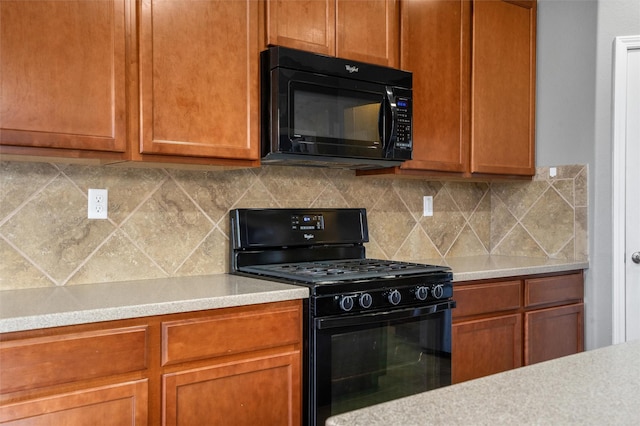 kitchen featuring tasteful backsplash and black appliances