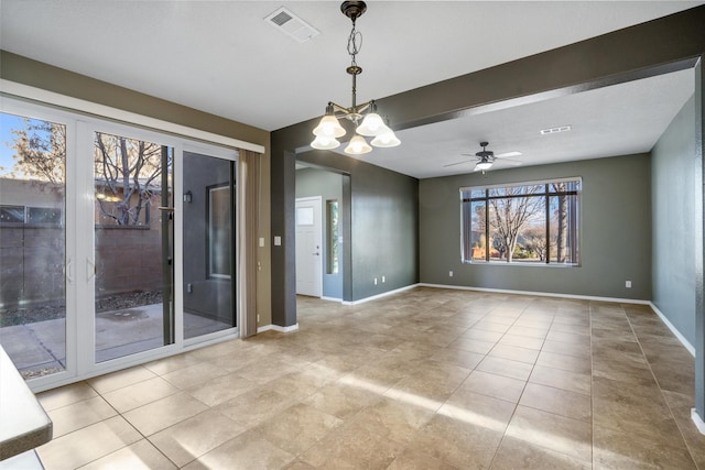 tiled spare room featuring beam ceiling and ceiling fan with notable chandelier