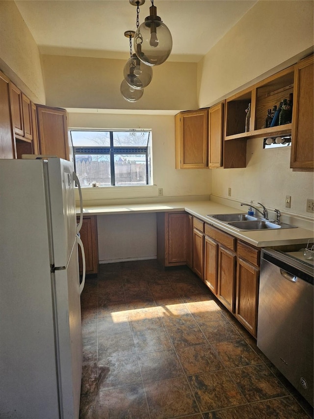 kitchen with white fridge, sink, dishwasher, and decorative light fixtures