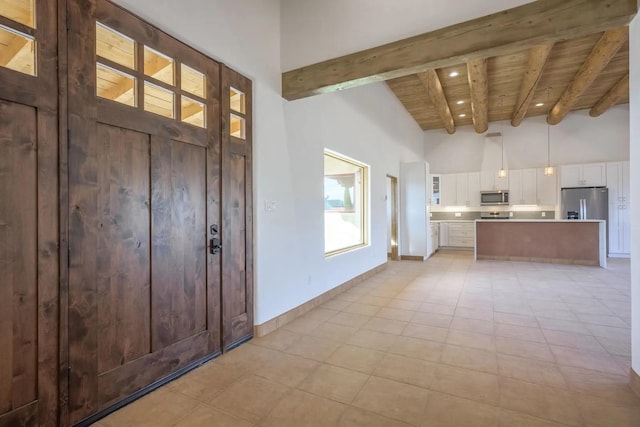 foyer featuring high vaulted ceiling, beamed ceiling, and wood ceiling