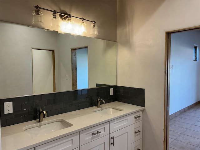 bathroom featuring tile patterned flooring, vanity, and tasteful backsplash