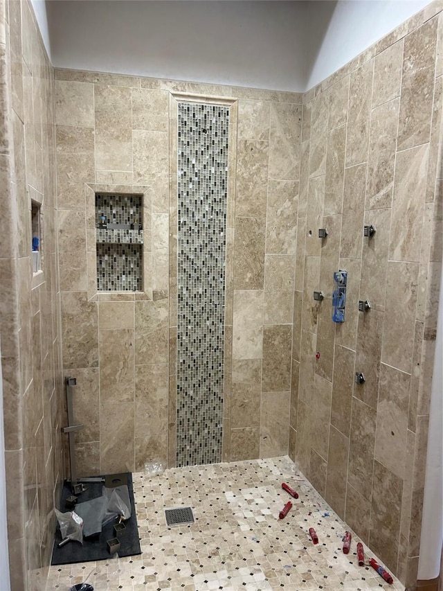 bathroom with a tile shower