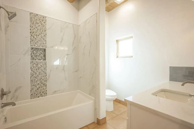 full bathroom featuring toilet, vanity, tiled shower / bath combo, and tile patterned flooring