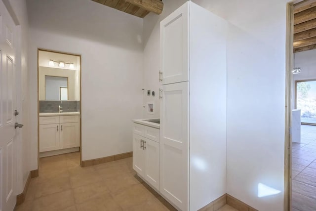 bathroom featuring tasteful backsplash, vanity, wood ceiling, and beamed ceiling