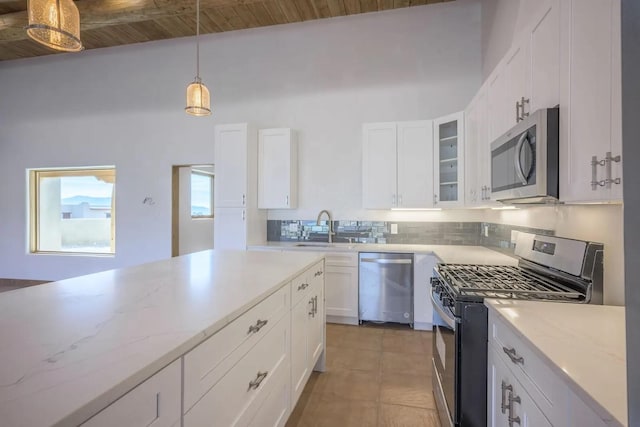 kitchen with white cabinetry, wooden ceiling, stainless steel appliances, decorative light fixtures, and sink