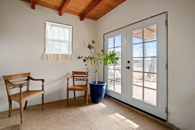 sitting room with french doors, lofted ceiling with beams, and wood ceiling