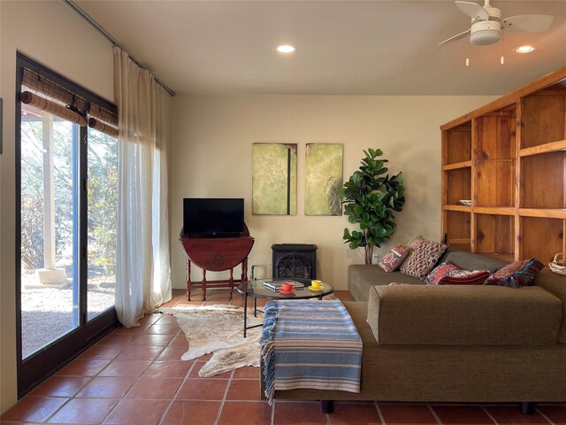 living room with ceiling fan and tile patterned flooring