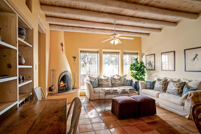 living room with a large fireplace, tile patterned flooring, wooden ceiling, ceiling fan, and beamed ceiling