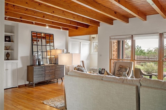 living room featuring beam ceiling, track lighting, wood ceiling, and wood-type flooring