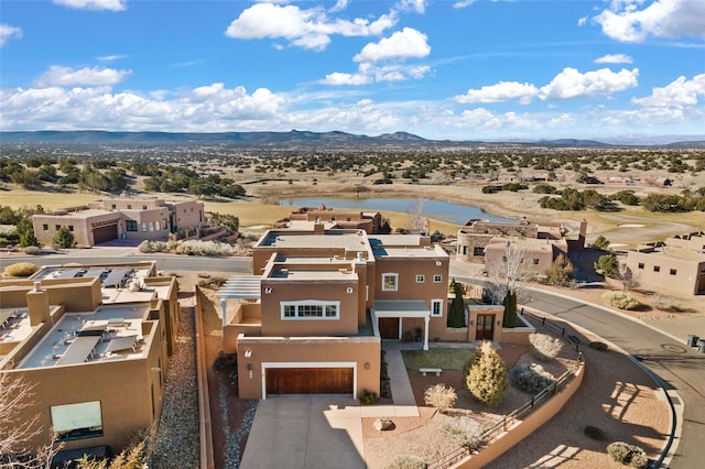 birds eye view of property with a water and mountain view