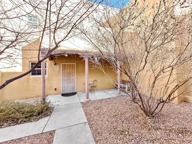 doorway to property featuring a patio area