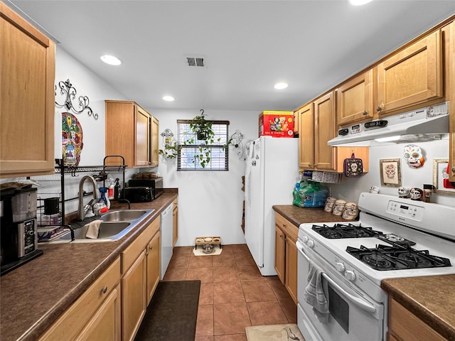 kitchen with white appliances, sink, and light tile patterned floors