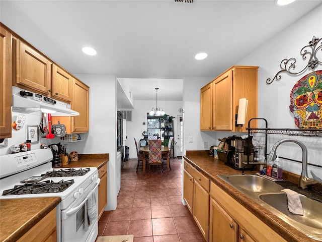 kitchen with sink, hanging light fixtures, a notable chandelier, white range with gas cooktop, and dark tile patterned flooring