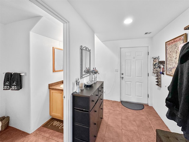 foyer entrance with light tile patterned flooring