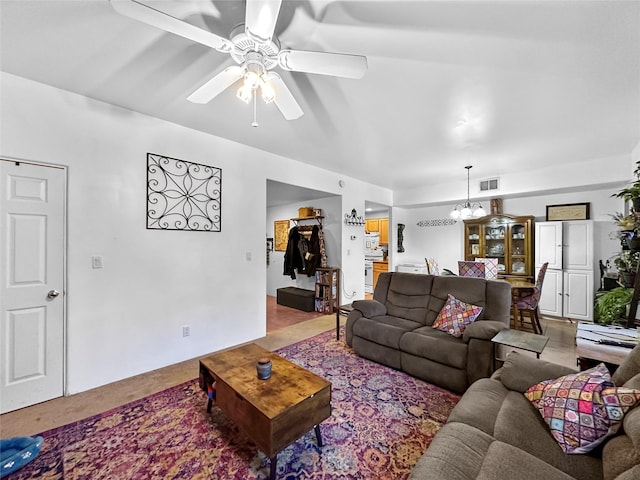 living room featuring ceiling fan with notable chandelier