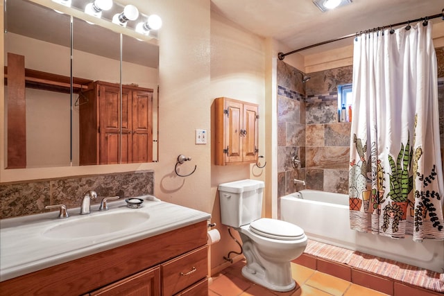 full bathroom featuring tile patterned flooring, vanity, toilet, and shower / bath combo with shower curtain